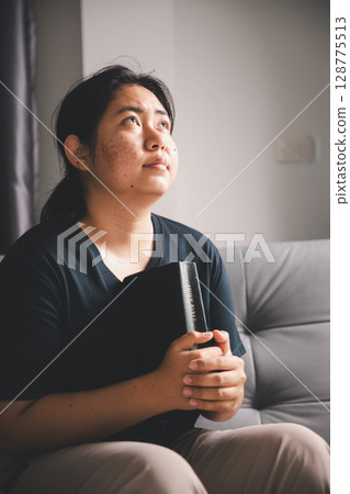 People and hope concept. Close up face female looking up feeling hope and faith. Woman praying. christianity faith, international day of prayer, female lost in thoughts feel lonely depressed pondering People and hope concept. Close up face female looking up feeling hope and faith. Woman praying. christianity faith, international day of prayer, female lost in thoughts feel lonely depressed pondering 128775513