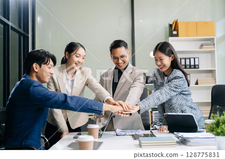 Young people professional colleagues are stretching arms showing team spirit focus on hands Young people professional colleagues are stretching arms showing team spirit focus on hands 128775831