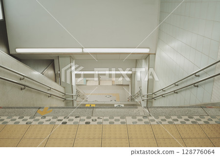 Barrier-free double handrail staircase (inside Saginuma Station, Kawasaki City) 128776064
