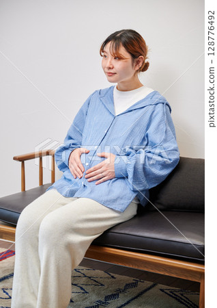 Pregnant woman, maternity, chair, heartwarming Pregnant woman, maternity, chair, heartwarming 128776492