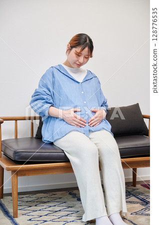 Pregnant woman, maternity, chair, heartwarming Pregnant woman, maternity, chair, heartwarming 128776535