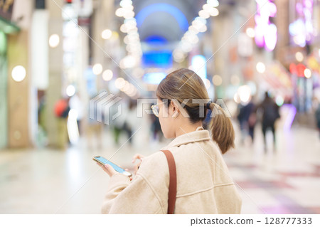 Woman tourist sightseeing Sendai shopping road. Happy traveler travel near Sendai station, Miyagi Prefecture, Japan. Famous Landmark and Vacation Woman tourist sightseeing Sendai shopping road. Happy traveler travel near Sendai station, Miyagi Prefecture, Japan. Famous Landmark and Vacation 128777333