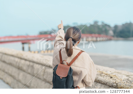 Woman tourist sightseeing Fukuura jima bridge or the bridge of romantic encounters for Fukuura Island at Matsushima Bay in Matsushima, Miyagi Prefecture, Tohoku, Japan. Landmark and famous Vacation Woman tourist sightseeing Fukuura jima bridge or the bridge of romantic encounters for Fukuura Island at Matsushima Bay in Matsushima, Miyagi Prefecture, Tohoku, Japan. Landmark and famous Vacation 128777344