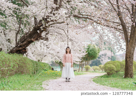 Woman tourist sightseeing Kajo Park Yamagata Castle Ruins with Sakura Cherry Blossom in Spring, happy traveler travel in Yamagata prefecture, Tohoku, Japan. famous Landmark for Travel and Vacation 128777348