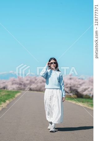 Woman tourist sightseeing Kitakami Tenshochi Park with Sakura Cherry Blossom in Spring, traveler travel in Kitakami festival, Iwate prefecture, Japan. Landmark for Travel and Vacation destination Woman tourist sightseeing Kitakami Tenshochi Park with Sakura Cherry Blossom in Spring, traveler travel in Kitakami festival, Iwate prefecture, Japan. Landmark for Travel and Vacation destination 128777371