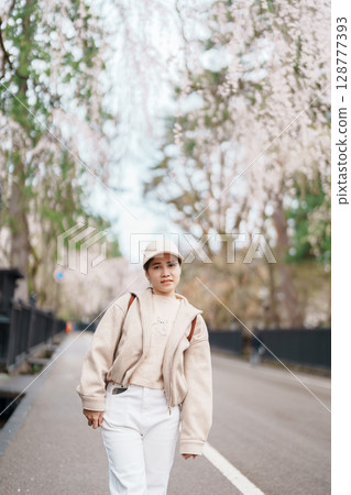 Woman tourist sightseeing Sakura Cherry Blossom in Spring. Happy traveler travel in Samurai village or Little Kyoto in Kakunodate town, Semboku District, Akita Prefecture, Japan. Landmark and Vacation 128777393