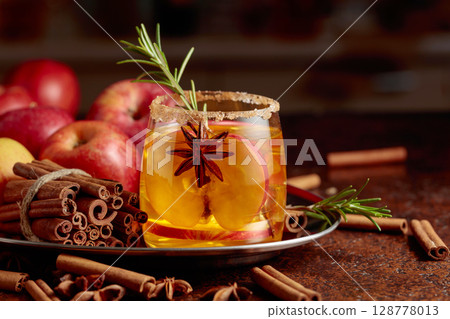 Apple kombucha with apple slices, anise, and a rosemary branch. 128778013