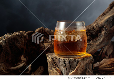Whiskey on ice on an old wooden stump. Whiskey on ice on an old wooden stump. 128778022