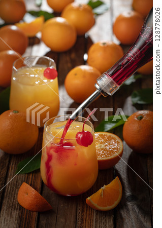 Classic tequila sunrise cocktail on an old wooden table. 128778026