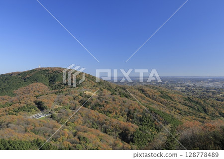 Asahi Pass, colored in autumn leaves, seen from a paragliding takeoff point near the summit of Mount Komachi in Ibaraki Prefecture on a clear, sunny late autumn day. Asahi Pass, colored in autumn leaves, seen from a paragliding takeoff point near the summit of Mount Komachi in Ibaraki Prefecture on a clear, sunny late autumn day. 128778489