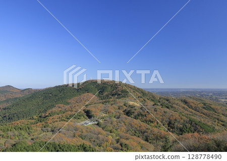 Asahi Pass, colored in autumn leaves, seen from a paragliding takeoff point near the summit of Mount Komachi in Ibaraki Prefecture on a clear, sunny late autumn day. Asahi Pass, colored in autumn leaves, seen from a paragliding takeoff point near the summit of Mount Komachi in Ibaraki Prefecture on a clear, sunny late autumn day. 128778490