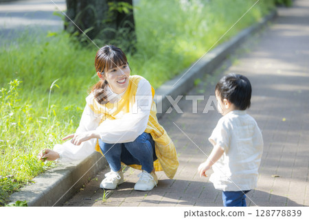 Parent and child playing in the park 128778839