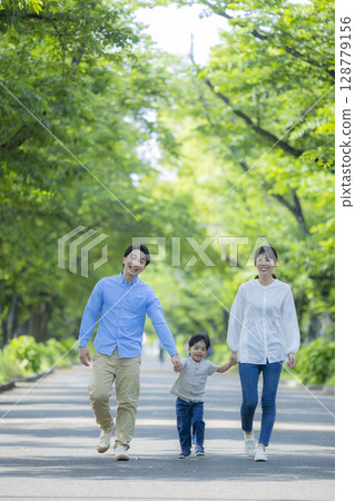 Family walking in the fresh green park 128779156