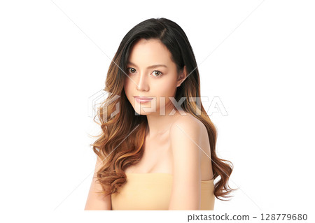 A beautiful young Asian woman with clean, fresh skin against a white background. Skincare, facial treatment, cosmetology, beauty, and spa. An elegant portrait of an Asian woman. 128779680