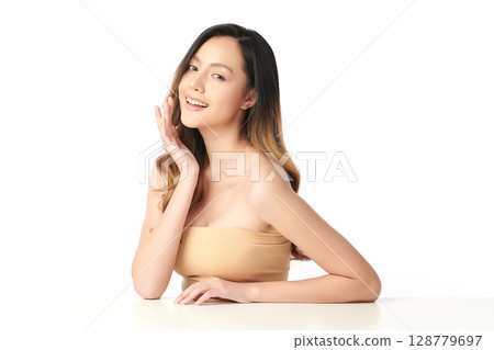 A beautiful young Asian woman with clean, fresh skin against a white background. Skincare, facial treatment, cosmetology, beauty, and spa. An elegant portrait of an Asian woman. 128779697
