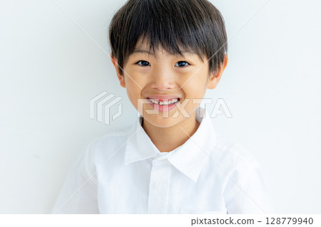 Portrait of an elementary school student on a white background Portrait of an elementary school student on a white background 128779940
