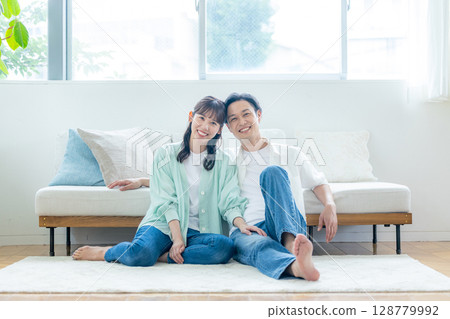 A young couple relaxing in the living room A young couple relaxing in the living room 128779992