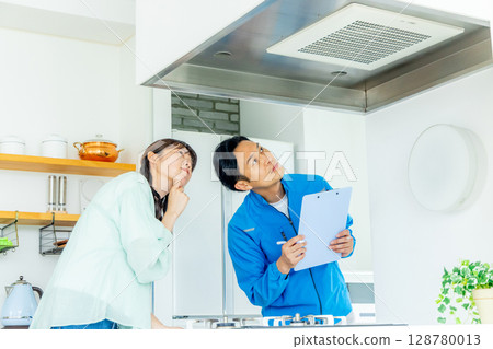 Worker checking the ventilation fan 128780013