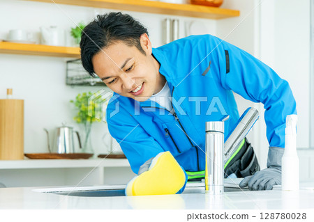 Man cleaning the kitchen 128780028