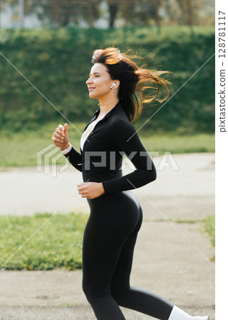 Woman Running With Flowing Hair Outdoors 128781117