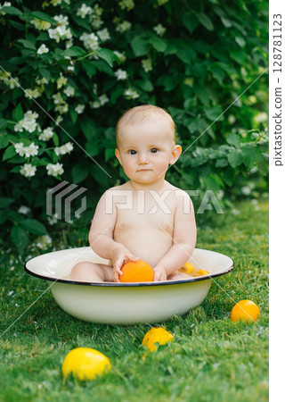 Baby Holding Lemon In Basin Outdoors Baby Holding Lemon In Basin Outdoors 128781123