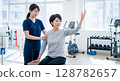 Rehabilitation: Female physiotherapist and patient 128782657