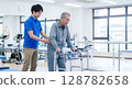 Rehabilitation: Male physiotherapist and patient 128782658