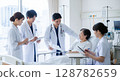 Doctor and nurse: examining a patient in a hospital room (rounds) 128782659