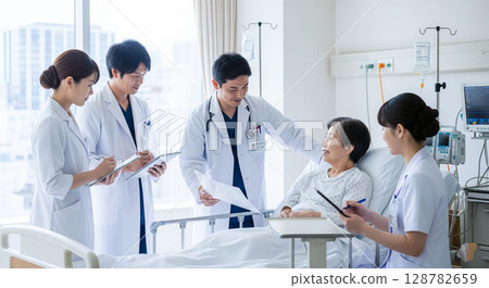 Doctor and nurse: examining a patient in a hospital room (rounds) 128782659