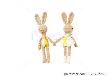 Two bunnies in yellow ribbons stand, isolated on white, PNG 128782703