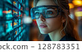 a woman in a modern office wearing AR glasses, interacting with holographic charts and digital tools 128783351