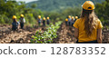 a woman leading a tree-planting initiative in a rural area, showing a group of volunteers where to plant saplings, with a natural environment and clear copy space on the right 128783352