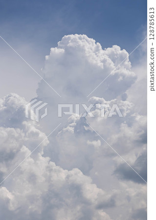 Cumulonimbus clouds rising in the blue sky 128785613
