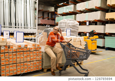 Exploring a home improvement store with a middle-aged woman while shopping for household items and Exploring a home improvement store with a middle-aged woman while shopping for household items and 128785694