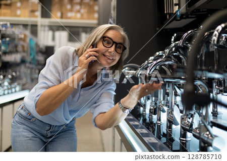 Woman explores home improvement store while shopping for household items and decor Woman explores home improvement store while shopping for household items and decor 128785710