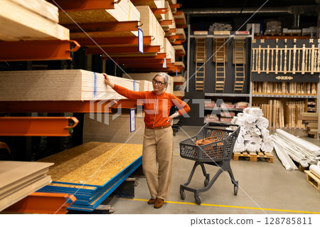 Woman shopping in a home improvement store, exploring materials and making selections in a vibrant 128785811
