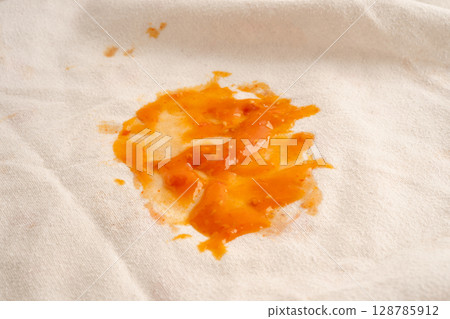Dirty tomato sauce stain or ketchup on cloth. Dirty tomato sauce stain or ketchup on cloth. 128785912