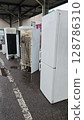 Discarded refrigerators awaiting recycling at an electronic waste facility on a rainy day in the city 128786310