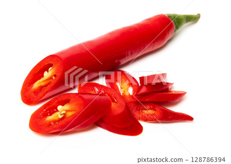 Sliced pods of red natural organic chili pepper on white background Sliced pods of red natural organic chili pepper on white background 128786394