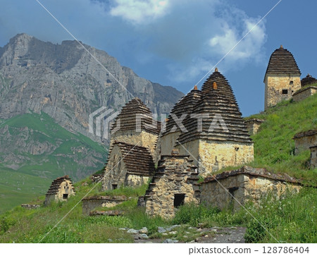 Dargavs, North Ossetia-Alania, Russia. City of the dead, ancient necropolis in the mountains of North Caucasus. Dargavs, North Ossetia-Alania, Russia. City of the dead, ancient necropolis in the mountains of North Caucasus. 128786404