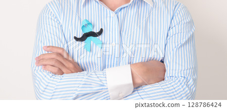 Man with blue Ribbon and mustache for Blue November, November Prostate Cancer Awareness month, World Diabetes day , Men Health month, International men, Father day. Healthcare and world cancer day 128786424