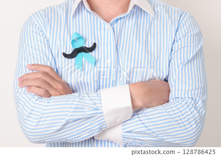 Man with blue Ribbon and mustache for Blue November, November Prostate Cancer Awareness month, World Diabetes day , Men Health month, International men, Father day. Healthcare and world cancer day 128786425