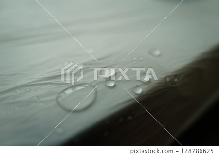 Close-up view of water droplets on a smooth surface Close-up view of water droplets on a smooth surface 128786625