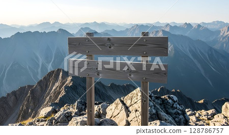 Blank wooden signpost on top of a mountain. Directional information board for trail and hike concept. Outdoor travel. 128786757