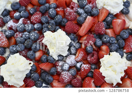 Delicious strawberry tart with blueberries, fresh raspberries and whipped cream, cheesecake, top 128786758