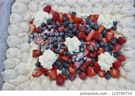 Delicious strawberry tart with blueberries, fresh raspberries and whipped cream, cheesecake, top 128786759