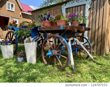 Stylish Provencal-style flower garden in a country house in summer. High quality photo Stylish Provencal-style flower garden in a country house in summer. High quality photo 128787232