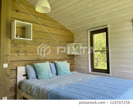 stylish bedroom in a modern style in a country house. High quality photo stylish bedroom in a modern style in a country house. High quality photo 128787256