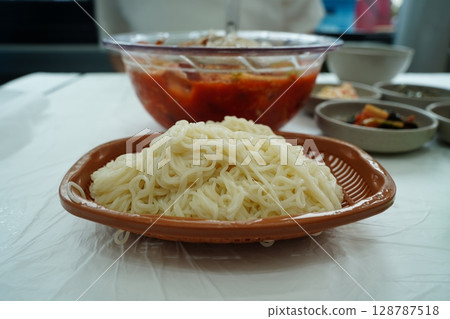 Traditional Korean spicy cold raw fish soup (Mulhoe) served with somen noodles on the side Traditional Korean spicy cold raw fish soup (Mulhoe) served with somen noodles on the side 128787518
