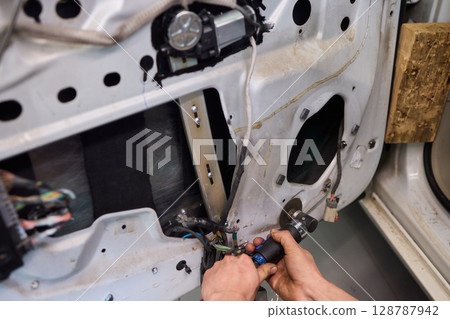 Hands Engaged in the Process of Performing Automotive Interior Repairs Effectively Hands Engaged in the Process of Performing Automotive Interior Repairs Effectively 128787942